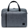 A grey Herschel messenger bag with a black handle and front full size pocket. Front pocket has the Hershel logo embroidered in black on the bottom right corner of front pocket.