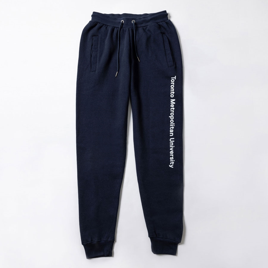 A navy fleece sweatpants features the "Toronto Metropolitan University" wordmark down the left leg, printed in white.