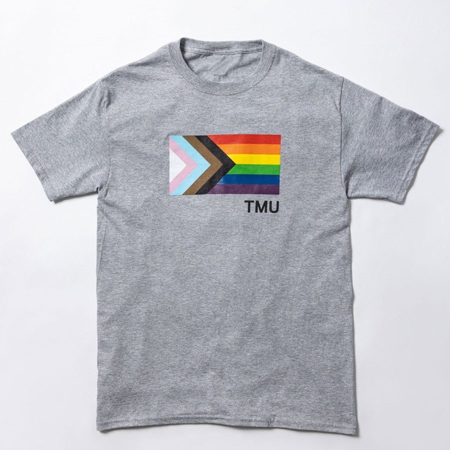 A short-sleeved heathered grey t-shirt features the Pride Progress flag with a small TMU in black.